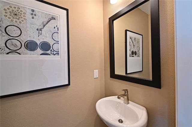 bathroom with a sink and a textured wall