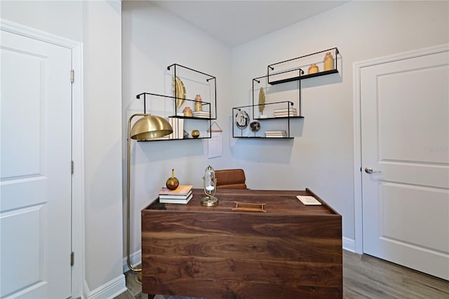 home office featuring wood finished floors and baseboards