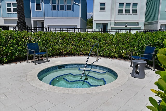 view of pool with a patio area, fence, and a community hot tub