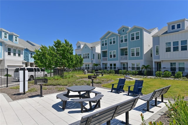 surrounding community featuring a yard, a residential view, and fence