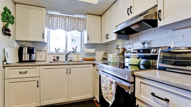 kitchen featuring white cabinetry, stainless steel range with electric stovetop, under cabinet range hood, and a sink