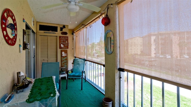 unfurnished sunroom featuring ceiling fan