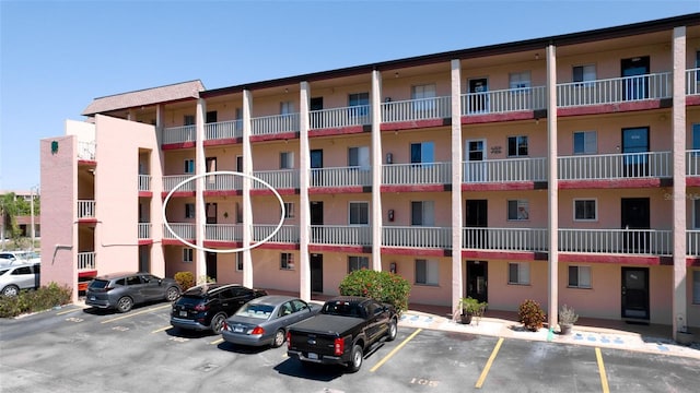 view of property featuring uncovered parking