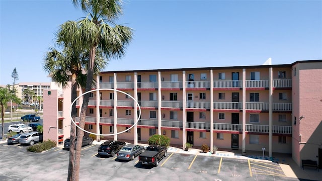 view of property featuring uncovered parking