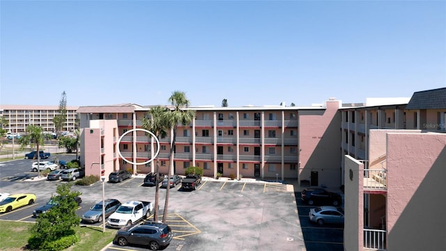 view of property featuring uncovered parking