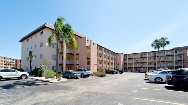 view of building exterior featuring uncovered parking