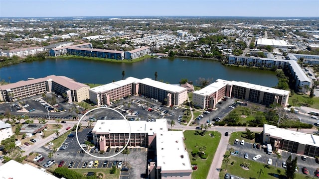 drone / aerial view featuring a water view and a view of city