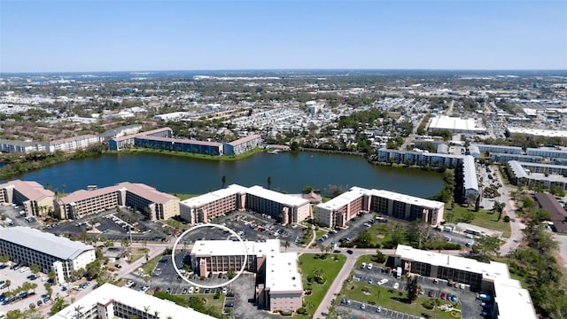 drone / aerial view featuring a view of city and a water view