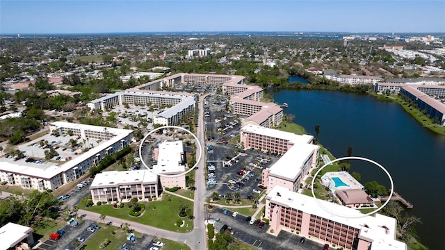 drone / aerial view featuring a city view and a water view