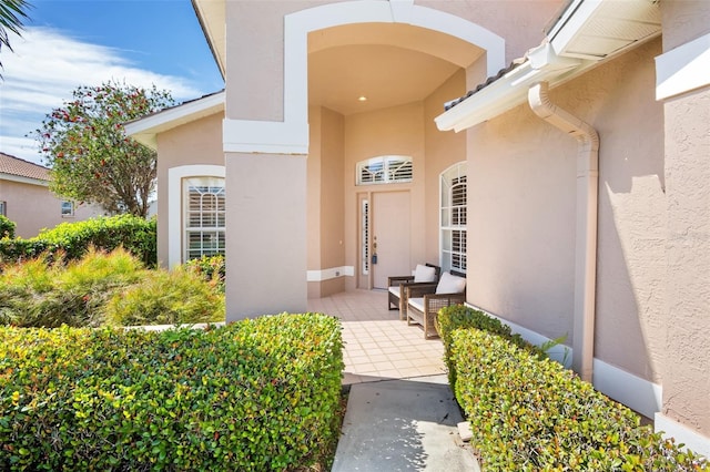 entrance to property with stucco siding