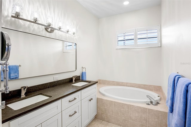 bathroom featuring double vanity, a garden tub, tile patterned flooring, and a sink