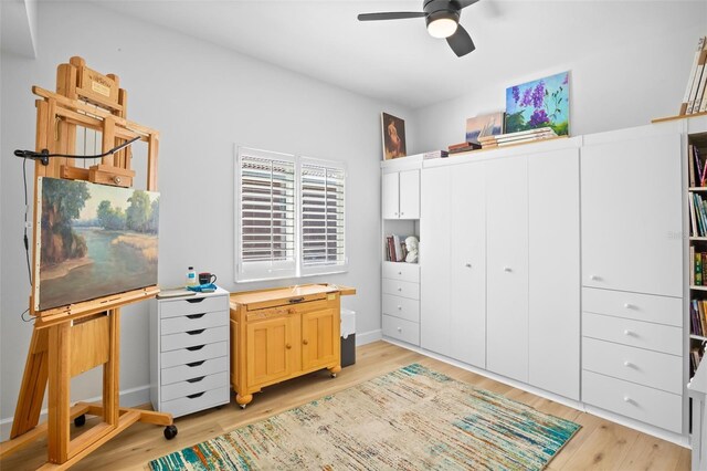 home office featuring ceiling fan, light wood-style flooring, and baseboards