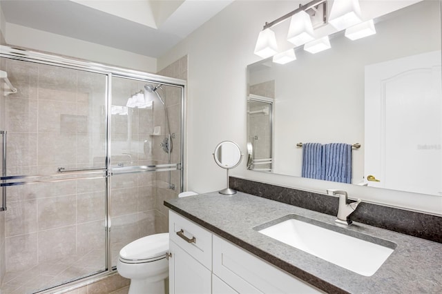 full bath featuring vanity, a shower stall, and toilet