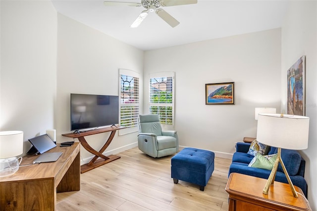 interior space with light wood-style floors, baseboards, and a ceiling fan