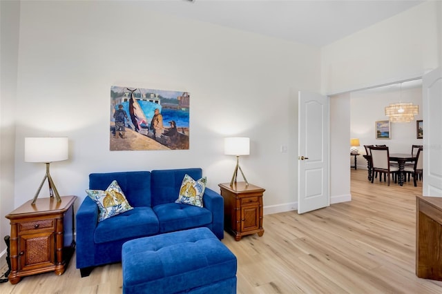 living room featuring light wood-type flooring and baseboards