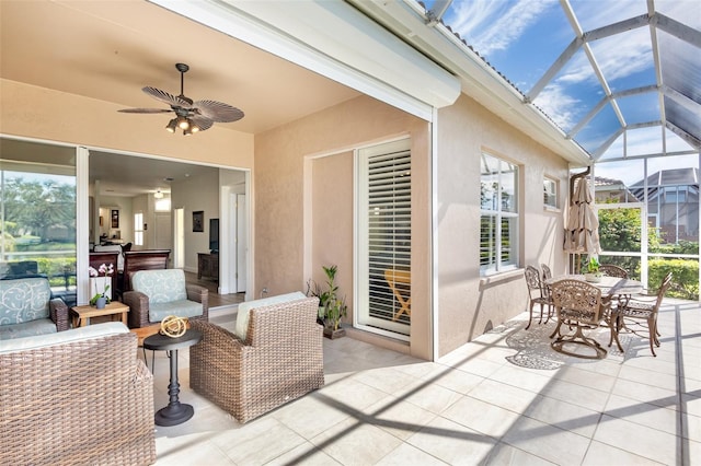 view of patio / terrace featuring a lanai, ceiling fan, outdoor dining area, and outdoor lounge area