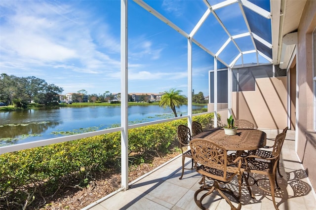 sunroom featuring a water view