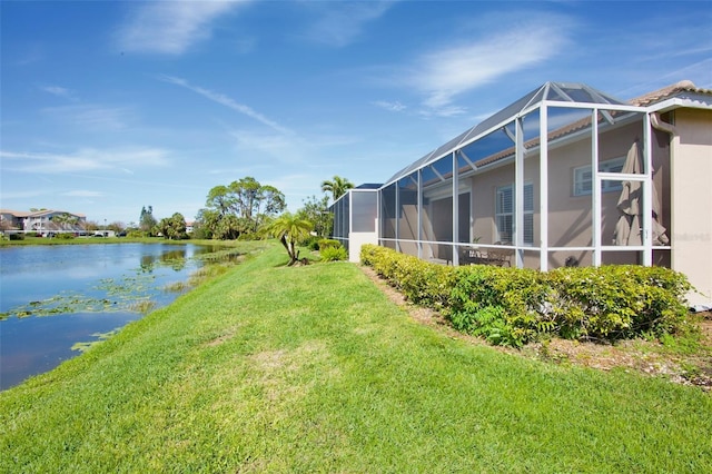 view of yard featuring a water view and a lanai