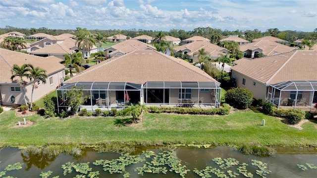 drone / aerial view featuring a water view and a residential view