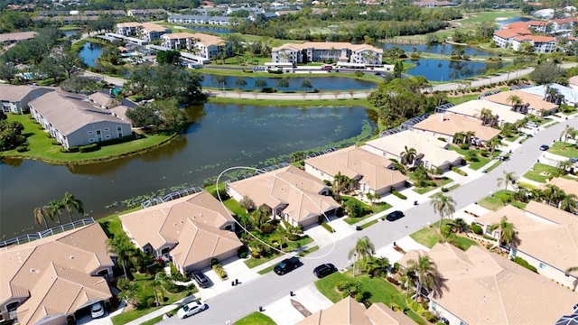 birds eye view of property with a water view and a residential view