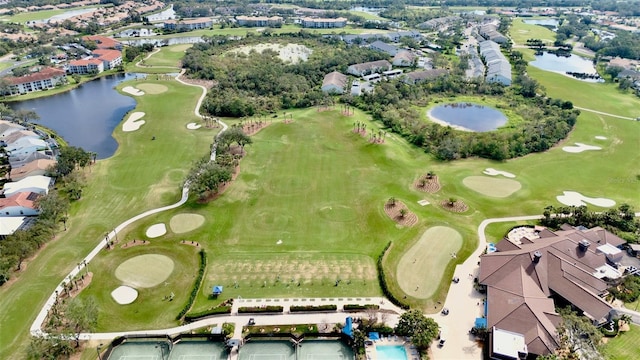 aerial view featuring a water view, view of golf course, and a residential view