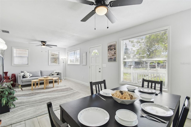 dining area featuring a ceiling fan, visible vents, and baseboards