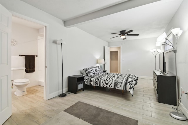 bedroom with beamed ceiling, wood tiled floor, connected bathroom, and baseboards