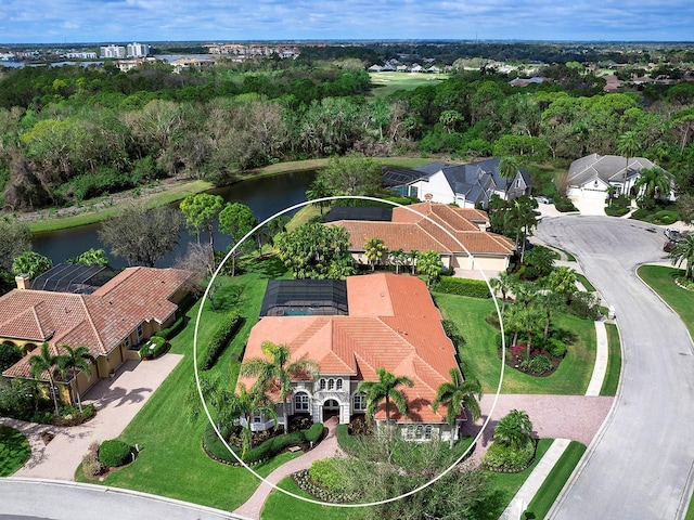 drone / aerial view with a water view and a residential view