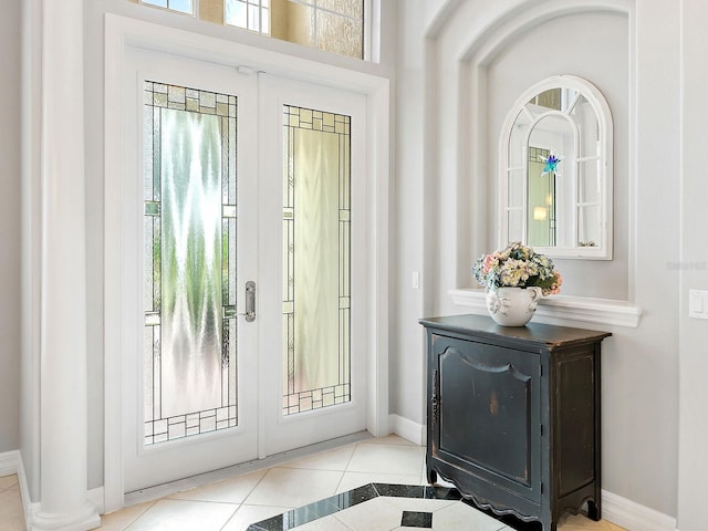 doorway to outside with tile patterned floors, baseboards, and french doors