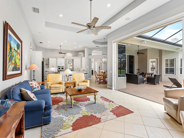 living area featuring light carpet, light tile patterned flooring, visible vents, and recessed lighting