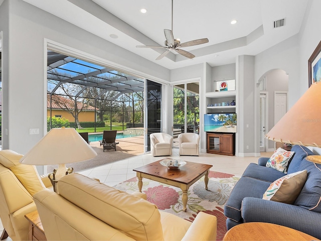 living area featuring recessed lighting, a sunroom, visible vents, and light tile patterned floors