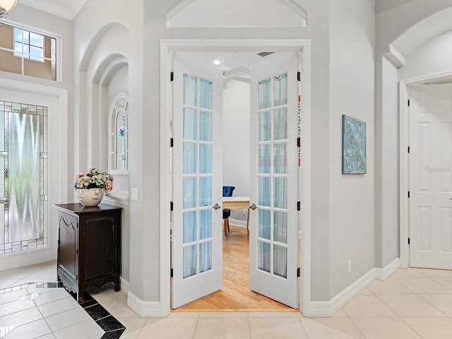 entryway with tile patterned flooring, french doors, and baseboards