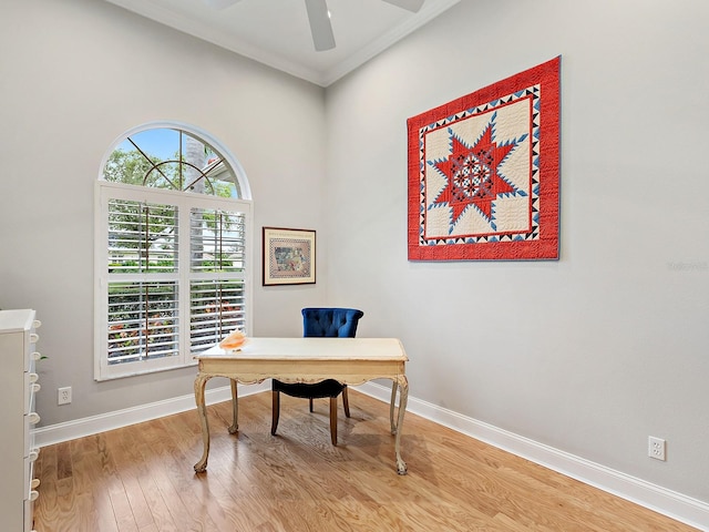 office with light wood-style flooring, crown molding, baseboards, and a ceiling fan