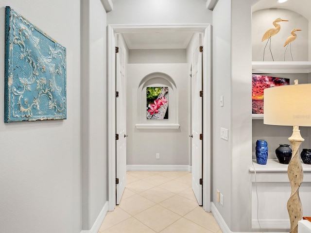 hall with tile patterned flooring and baseboards