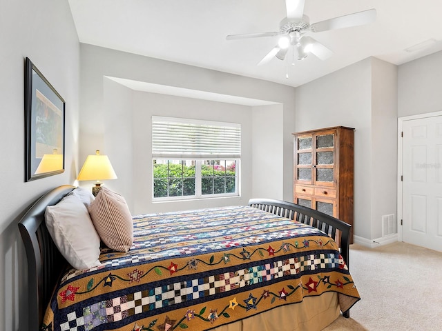 carpeted bedroom featuring baseboards, visible vents, and a ceiling fan