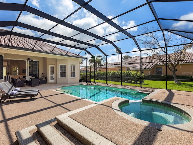 view of pool with a lanai, a pool with connected hot tub, an outdoor living space, a ceiling fan, and a patio area