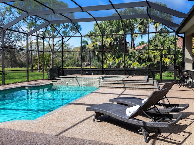 outdoor pool with glass enclosure and a patio area