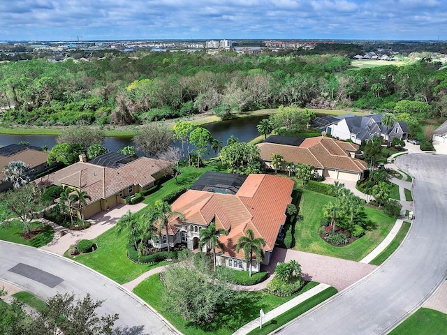 drone / aerial view with a water view and a residential view