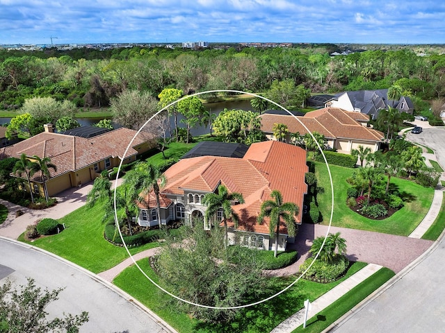 drone / aerial view with a wooded view