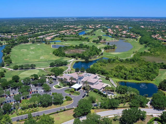 birds eye view of property with view of golf course and a water view