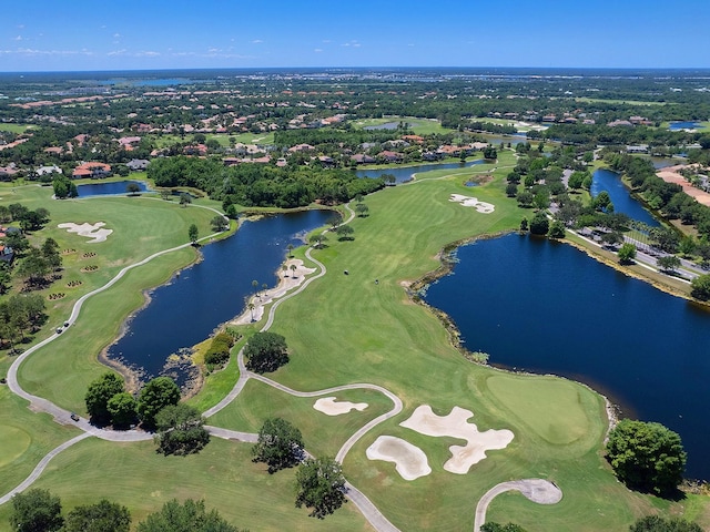 birds eye view of property featuring view of golf course and a water view