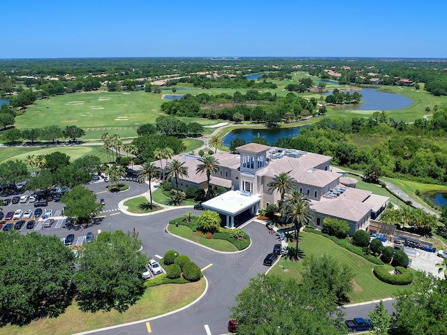 birds eye view of property with a water view and view of golf course