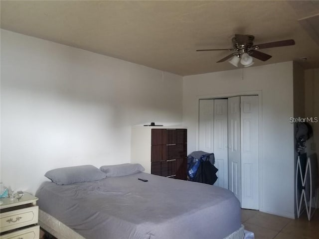 bedroom featuring tile patterned flooring, a closet, and ceiling fan