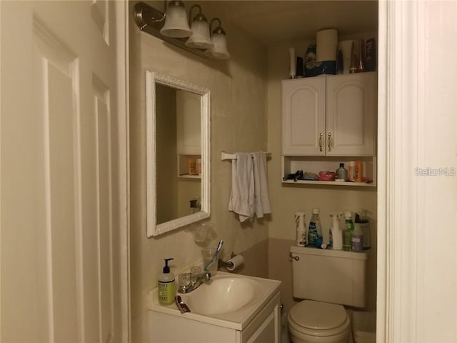 half bath featuring toilet and vanity