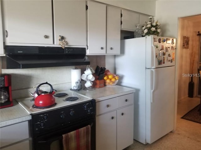 kitchen featuring electric range, freestanding refrigerator, light countertops, under cabinet range hood, and backsplash