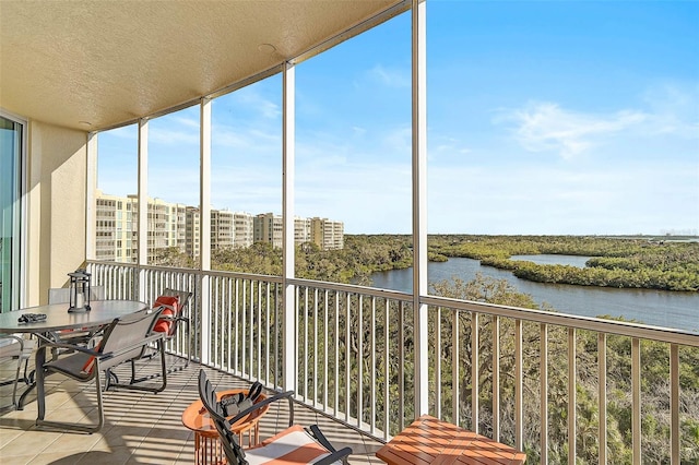 unfurnished sunroom featuring a water view