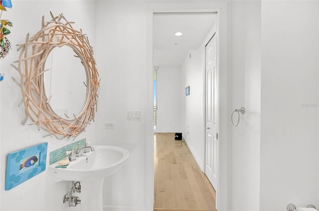 bathroom with baseboards and wood finished floors