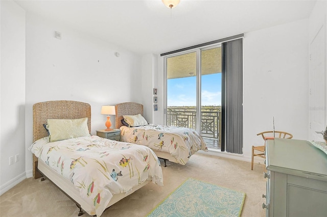 bedroom with access to exterior, baseboards, and light colored carpet