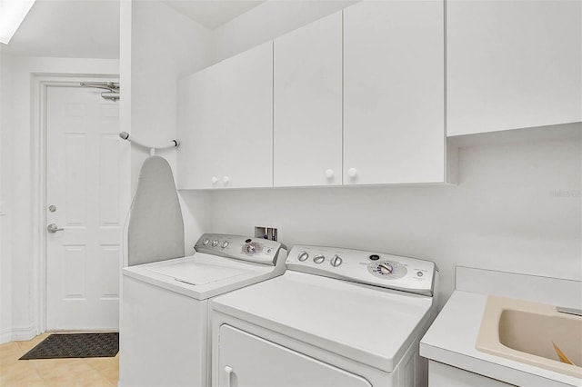 laundry area with cabinet space, washer and clothes dryer, and light tile patterned flooring