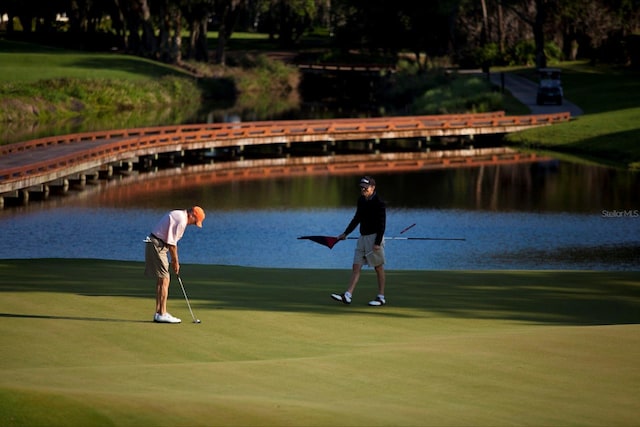 view of community featuring golf course view and a water view